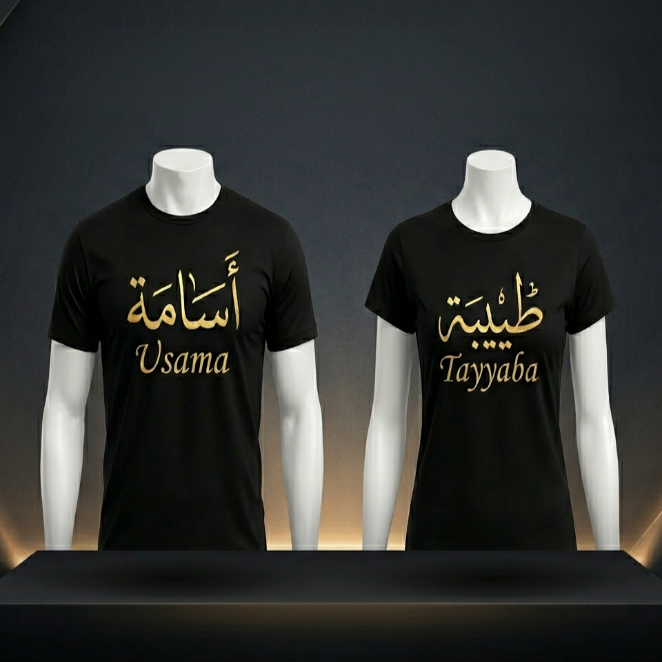 Two black t-shirts with gold text on mannequins against a dark background
